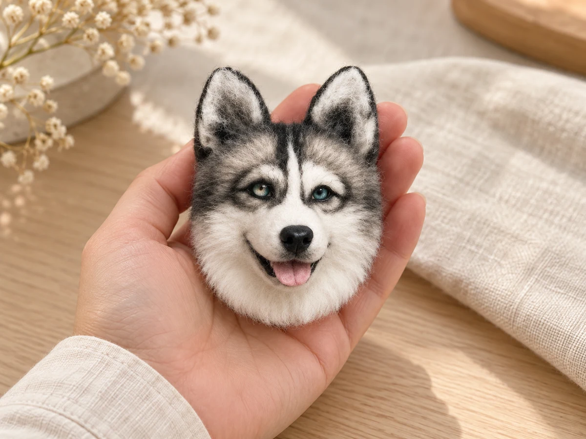 Miniature husky wool head held in a palm